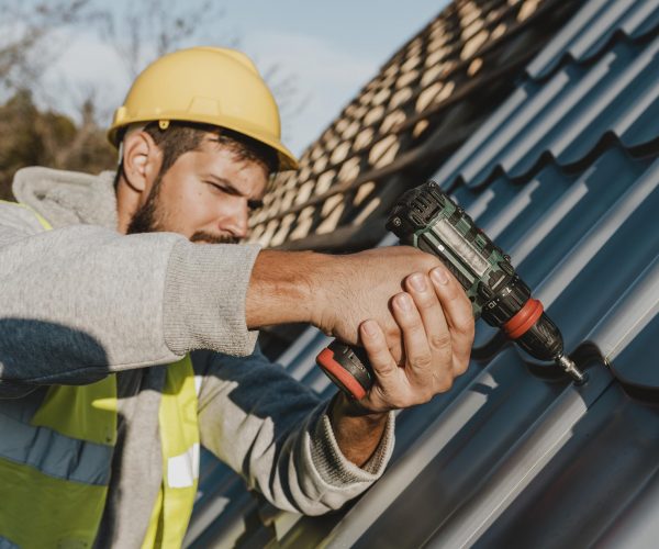 side-view-man-working-roof-with-drill side-view-man-working-roof-with-drill